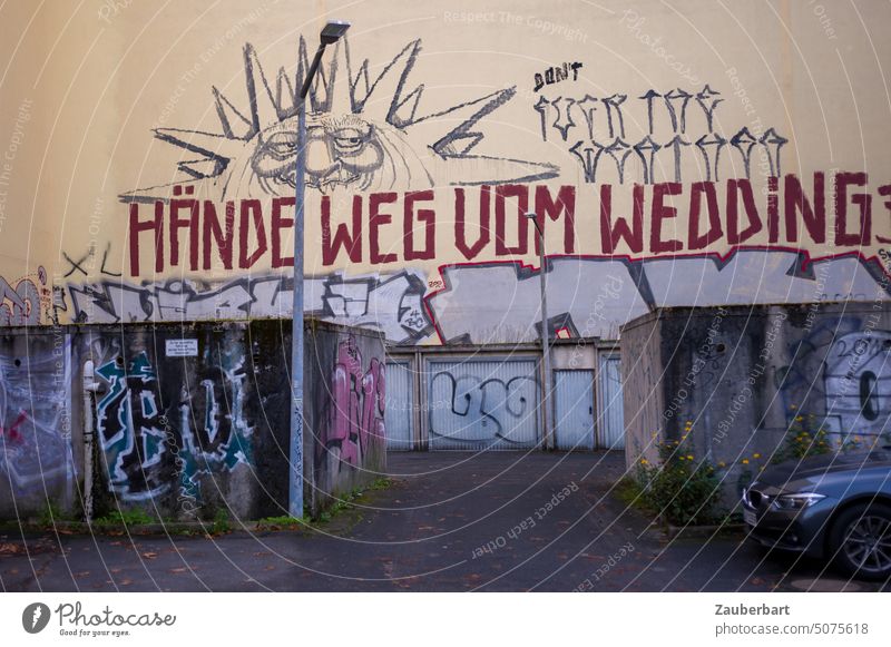 Hands off Wedding - slogan on a fire wall, in front of it garages, driveway and street lamp Berlin Graffiti street art Highway ramp (entrance) garage entrance