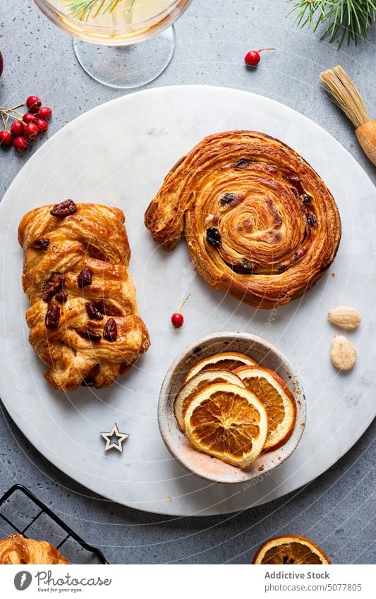 Delicious baked pastries with Christmas decoration food pastry plait sweet roll plate christmas homemade pine tree tradition arrangement cuisine table dessert