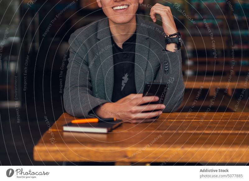 Focused man using smartphone in cafe chat notebook rest cafeteria plan surfing internet focus businessman formal classy message browsing social media wireless