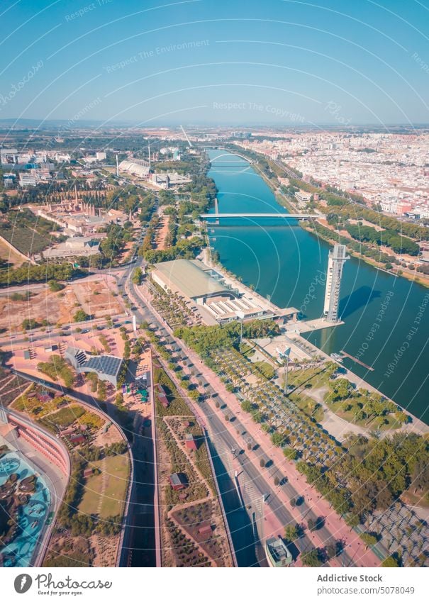 City of Seville with river and bridges under cloudless sky city seville multistory house blue sky andalusia building spain architecture turquoise cityscape