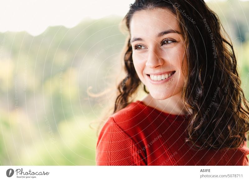 Cheerful young beautiful woman looking away outdoor portrait happy smile tooth cheerful toothy beauty face brunette close up positive wavy hair red orange