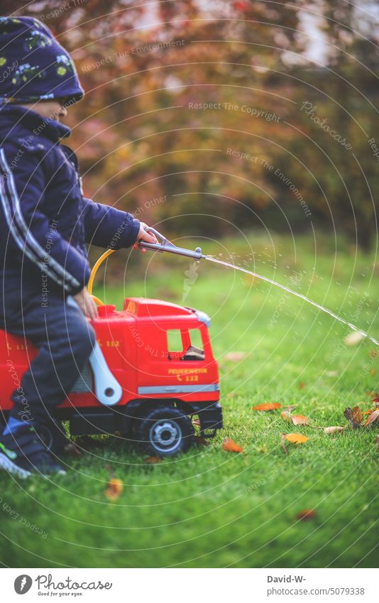 Boy playing on the fire truck Playing Boy (child) Fire department Garden Infancy Fireman cheerful Toys Water Erase Child