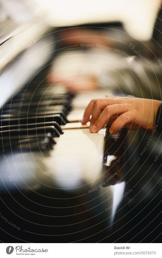 Children play piano together Piano Playing children at the same time Duet Music Family musical Piano keys Piano lessons Girl Boy (child) Fingers hands