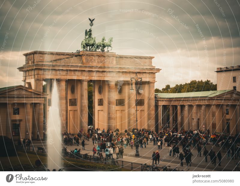 Tourists visit the Brandenburg Gate Tourist Attraction Landmark Sightseeing Pariser Platz Downtown City trip Downtown Berlin Capital city Historic Famousness