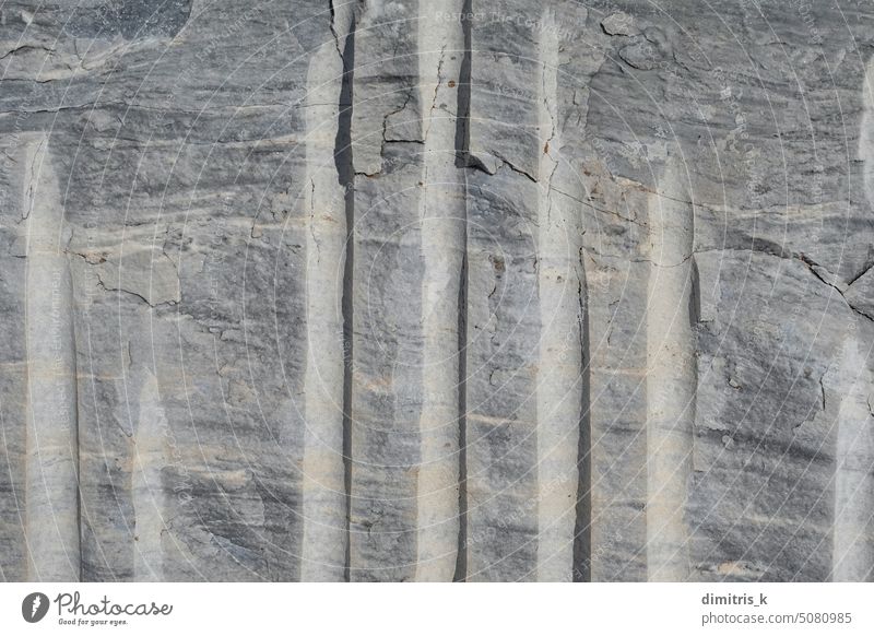 marble with extraction cuts background texture stone block quarry metamorphic rock closeup abstract natural grungy cracked gray lines detail macro slate