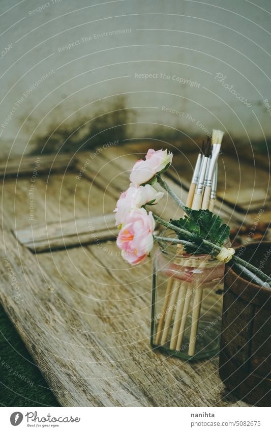 Romantic and nostalgic background with flowers and brushes against old wooden texture romantic rustic art aged vintage retro bouquet rusty artistic poetry mood