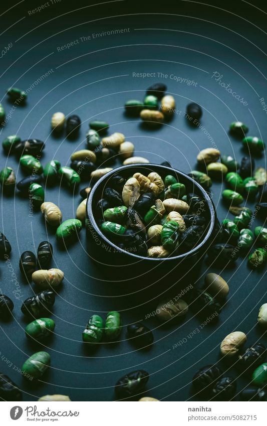 Elegant flat lay in dark tones of three color roasted edamame soya gourmet background minimal minimalistic flatlay pattern food texture mood elegant elegance