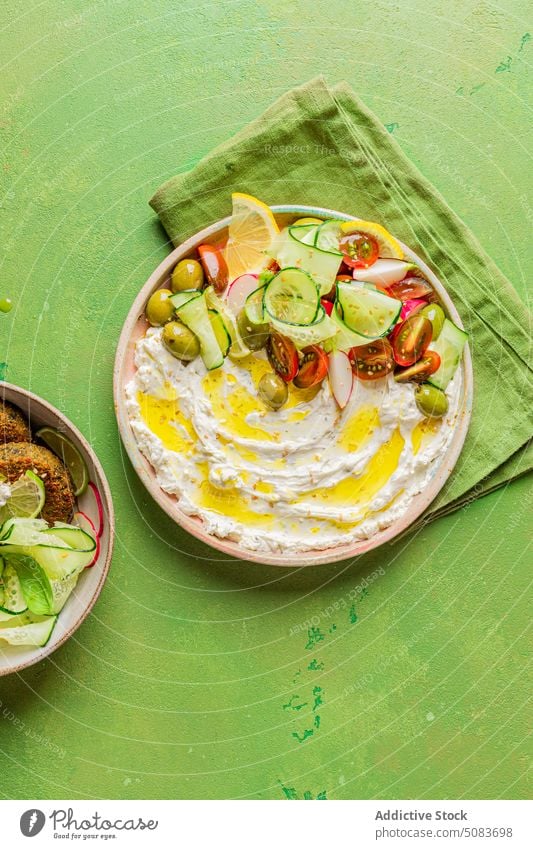 Plate with cream cheese and vegetables salad napkin plate vegetarian dish serve healthy portion bright colorful mediterranean cuisine fritter vegan dip feast