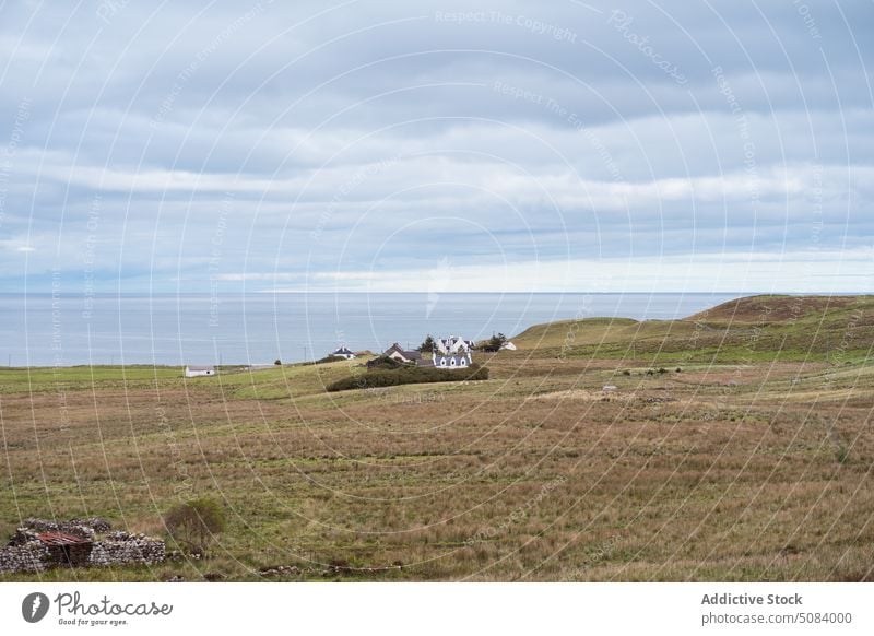 Lonely house on green meadow near lake valley pond nature countryside landscape farm water calm skye island scenic picturesque field scenery peaceful tranquil