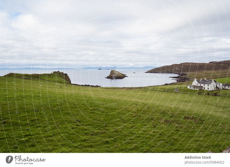 Lonely house on green meadow near lake valley pond nature countryside landscape farm water calm skye island scenic picturesque field scenery peaceful tranquil