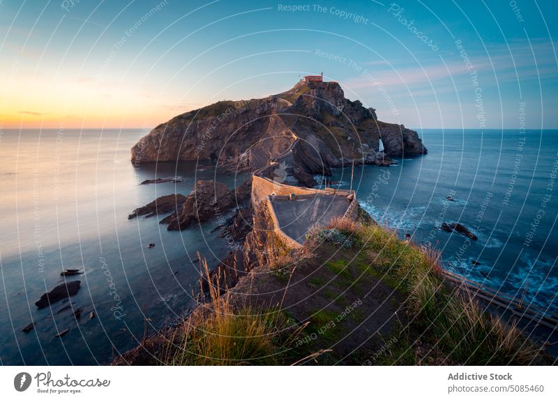 Ancient bridge with arches near sea at sunset scenery ancient rocky cliff road nature water picturesque breathtaking ocean old stone marine magnificent