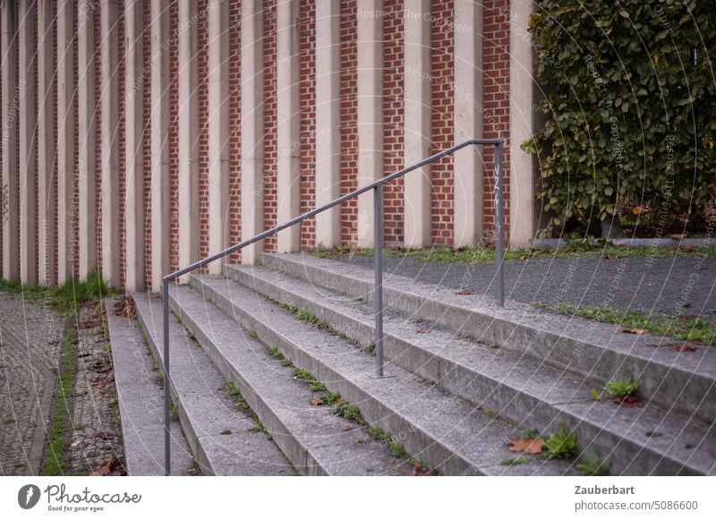 Stair treads and railing in front of brick wall with vertical struts Stairs stair treads Upward Wall (building) Aspire Vertical Elegant Delicate Banister