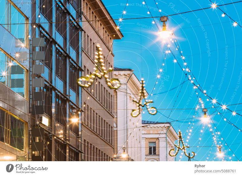 Helsinki, Finland. Evening Christmas Xmas New Year Festive Illumination Hanging On Electric Wires On Aleksanterinkatu Street holiday building twilight christmas