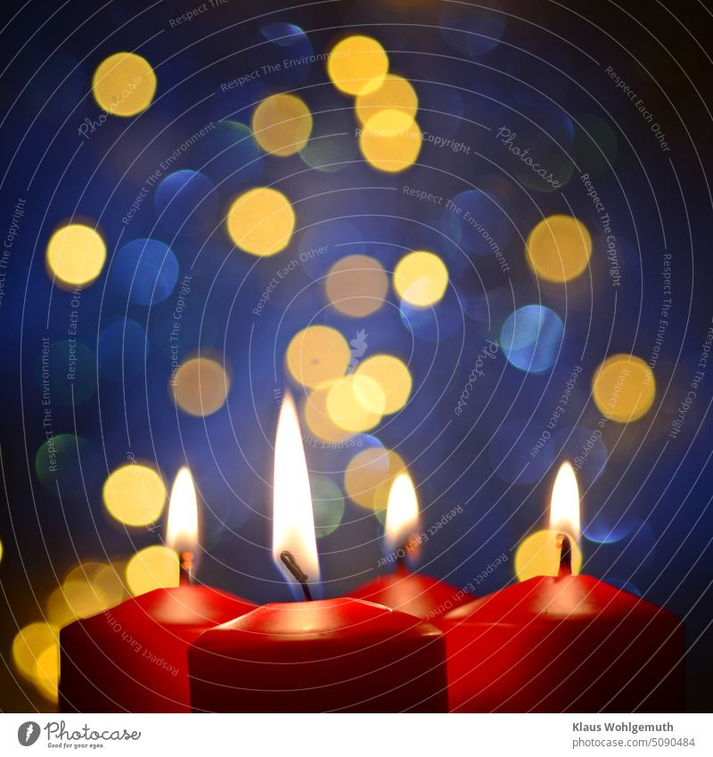 4th advent, 4 red candles burning on blue background with blue and gold reflections Advent shoulder stand Candlelight Candlewick Candle flame bokeh