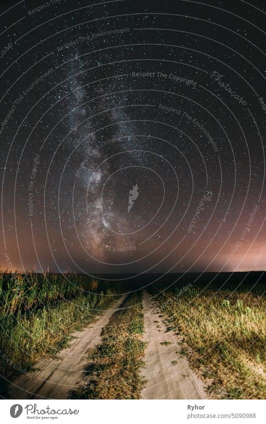 Night Starry Sky With Milky Way Glowing Stars Above Country Road In Countryside And Green Field Landscape field star space light farm night stars sky meadow