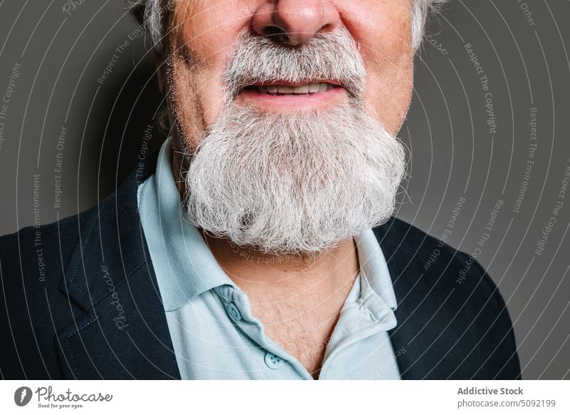 Crop elderly man smiling in studio portrait senior close up crop human face studio shot mouth smile expressive aged male classic gray hair beard pensioner