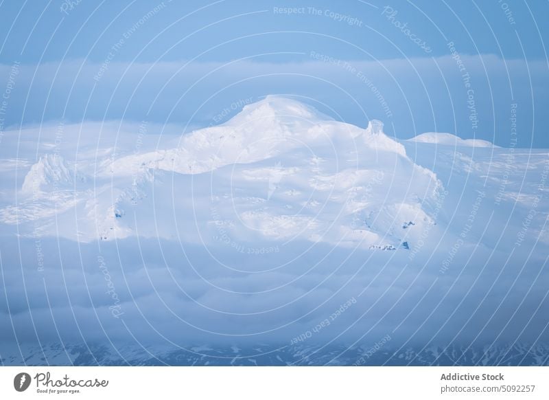 Snowy mountains in clouds in winter landscape snow sky peak cover cold ridge range slope breathtaking picturesque season spectacular summit twilight amazing