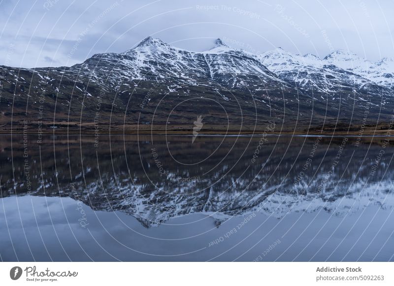 Majestic mountains of East Fjords in Iceland near lake majestic water crystal reflect huge snow cloudy gloomy sky east fjords cold nature environment weather