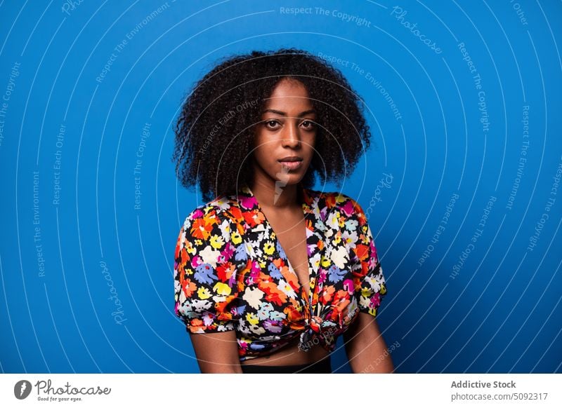 Young African American woman looking at camera style outfit model appearance modern individuality colorful bright portrait female young black african american