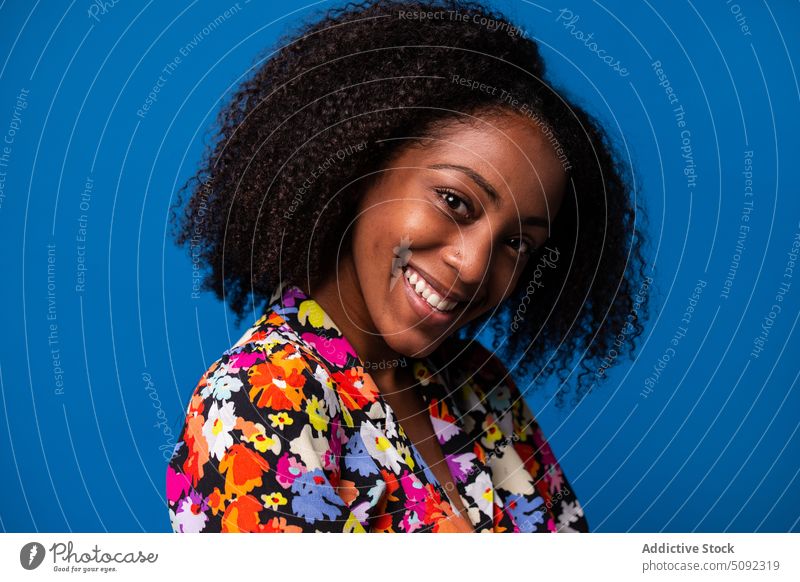 Happy black woman smiling in studio smile style happy curly hair model colorful female young african american ethnic positive optimist joy outfit shirt skirt