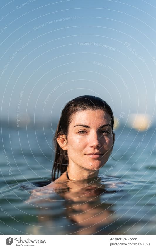 Woman submerging in water of sea in summer woman submerge aqua swim calm recreation vacation female wet hair environment resort leisure pleasure enjoy carefree