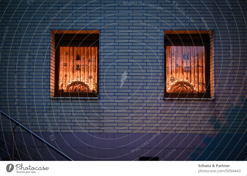 two windows of a residential house with Christmas lights behind the curtains Lighting Detached house Warm light Christmas & Advent Illuminate Moody Decoration