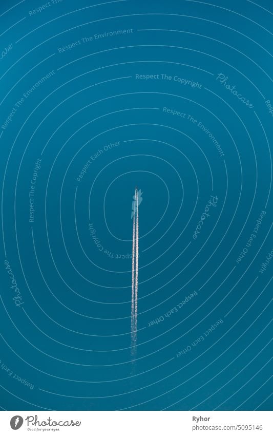 Contrail In Blue Sky. Aircraft Plane In Clear Sunny Sky Background background jet sky high clear fuel white pollution bright smoke travel line blue atmosphere