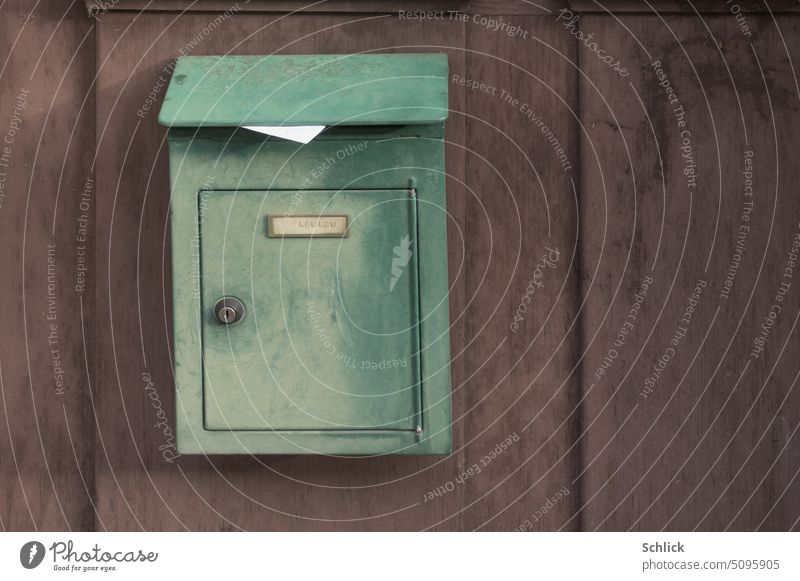 Love letter for Loulou, letter sticks out of green mailbox on purple wooden wall Mailbox Green Letter (Mail) Stick out Violet Wood Wall (building) closeup