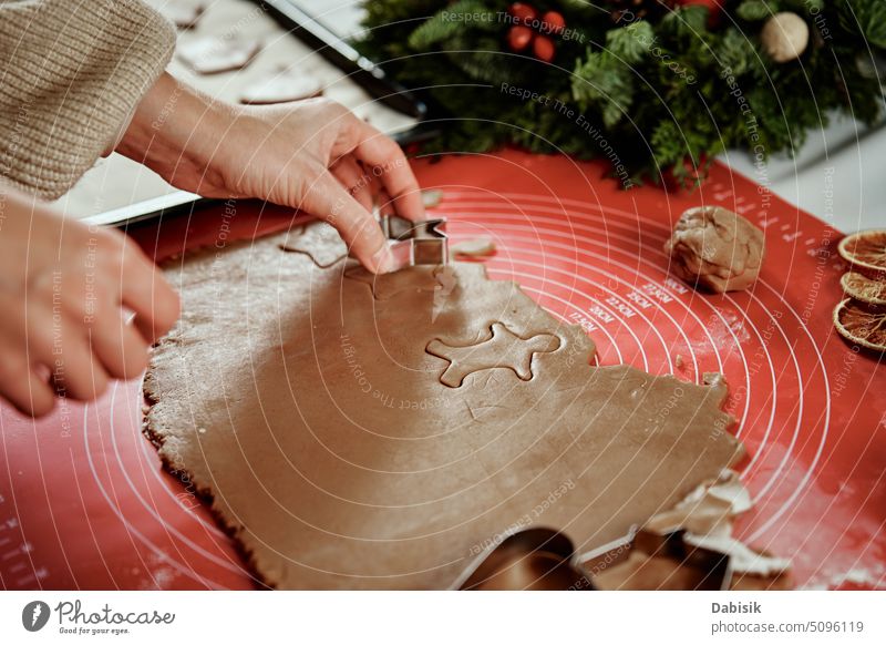 Process of woman making gingerbread cookies at home cooking cutter dough kitchen homemade christmas culinary food baking traditional holiday recipe biscuit