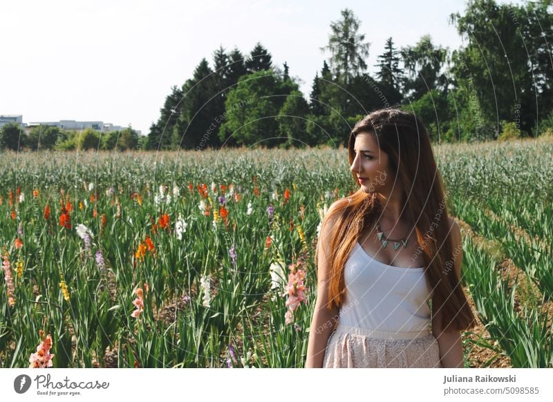 young woman with long brunette hair in flower field Exterior shot Colour photo Brunette Feminine Youth (Young adults) naturally 18 - 30 years Day Adults pretty