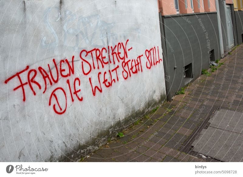 Women strike - the world stands still. written graffiti on a house wall Gender equality Awareness women Equality unequal treatment Impact Fairness Gender order