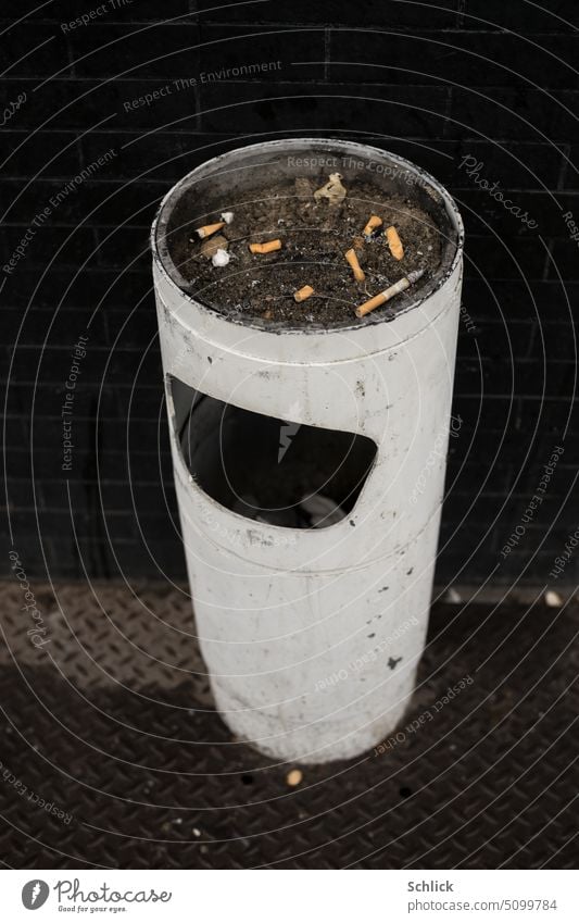 Smoking only in the fresh air, white ashtray with trash can in front of black wall Ashtray White Wall (building) Black Mülleiner Mülleinwurf tip cigarette butt