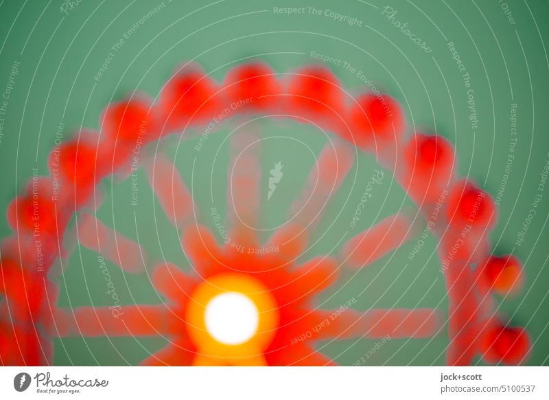 It turns a big wheel in green and red Ferris wheel Sky Theme-park rides Circular Light (Natural Phenomenon) Design Structures and shapes Silhouette Experimental