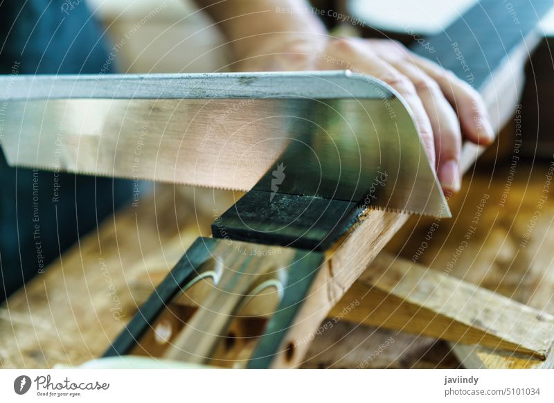 Spanish guitar maker marking the frets on the neck of a flamenco guitar. craftsman cut knife workbench luthier workshop professional wooden male instrument