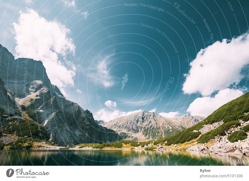 Tatra National Park, Poland. Calm Lake Czarny Staw under Rysy And Summer Mountains Landscape. Beautiful Nature, Scenic View Of Five Lakes Valley. UNESCO World Heritage Site