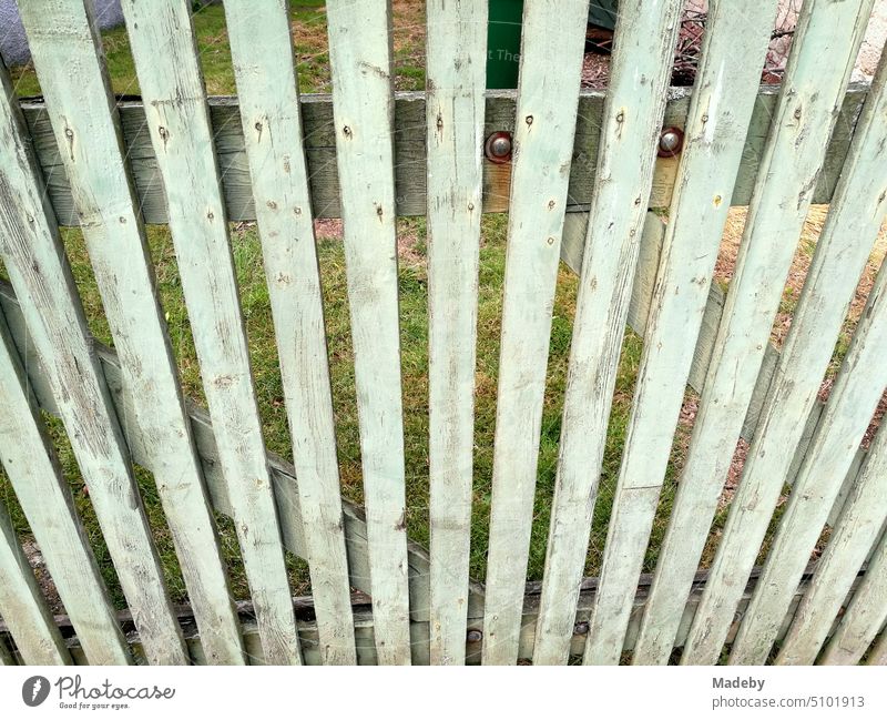 Old wooden fence in spring sunshine at the gardens in Weinberggasse in the old town of Blomberg in East Westphalia-Lippe, Germany Wooden fence Grass Sky Nature