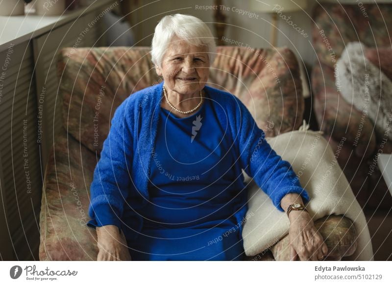 Portrait of an elderly woman in her home smiling happy enjoying positive people senior mature female house old aging domestic life grandmother pensioner retired