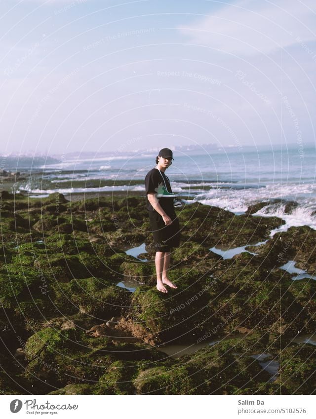 Young man, rocks and waves. Lovely natural scenery young adult Freedom Nature Nature photo nature lovers Man nature photography nature background