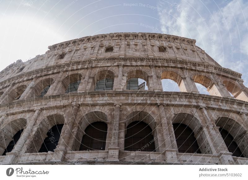 Arches of ancient weathered building arch exterior gray sky landmark architecture famous rome italy colosseum sightseeing heritage historic attract culture old