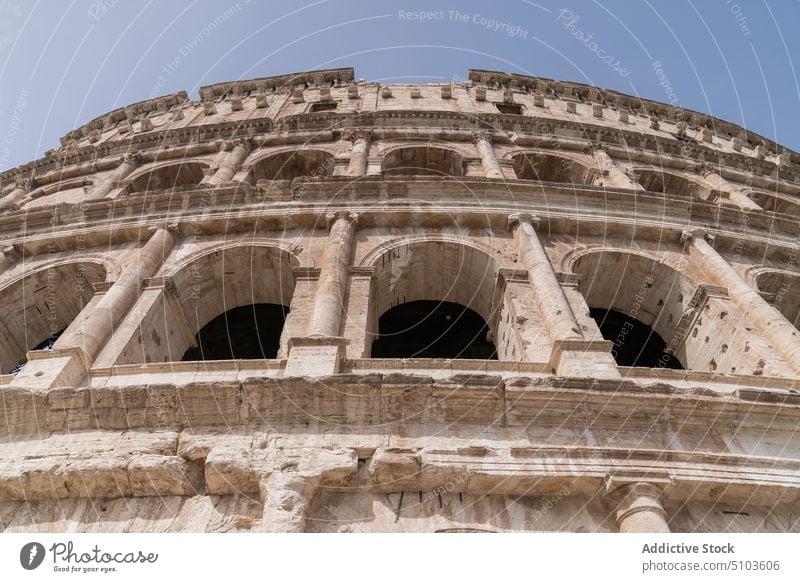 Arches of ancient weathered building arch exterior gray sky landmark architecture famous rome italy colosseum sightseeing heritage historic attract culture old