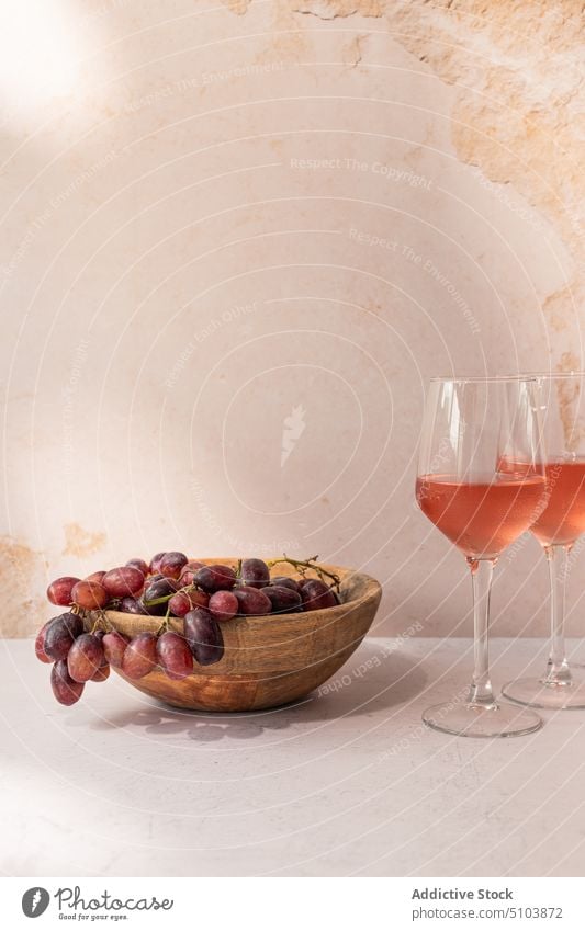 Glasses of wine with fruits on table glass drink bowl grape fig serve food slice red beverage tasty vitamin delicious fresh ripe nutrition organic yummy