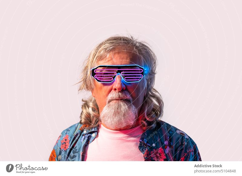 Senior male in led rave glasses in studio man sunglasses party retrowave creative charismatic personality style model portrait elderly accessory individuality