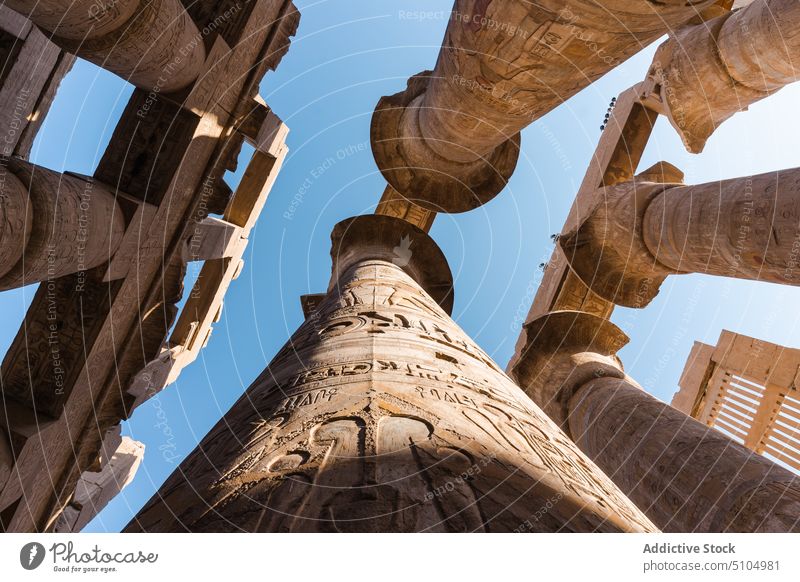 Ancient ornamental columns in old temple against blue sky architecture heritage historic culture landmark relief sightseeing travel ancient religion tourism