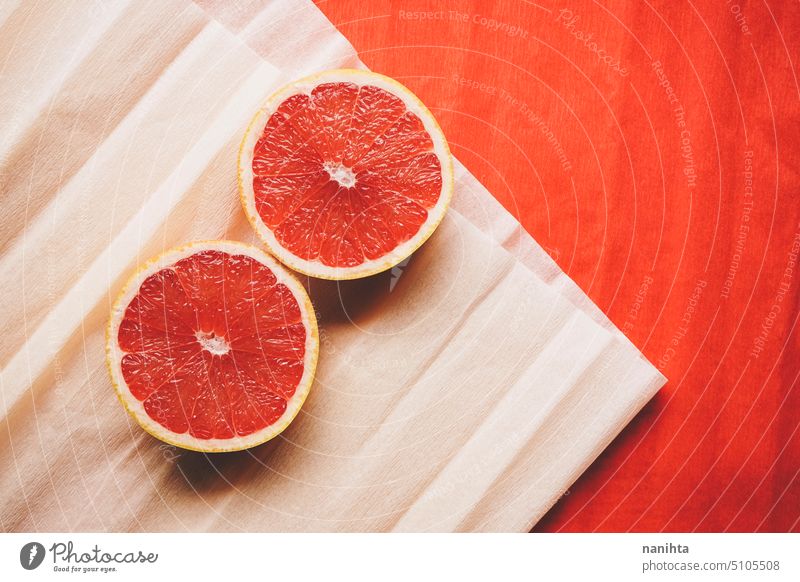 Colorful background in coral and red with fresh open grapefruit texture paper orange peach color juicy new citric healthy temptation vegan vibrant colorful