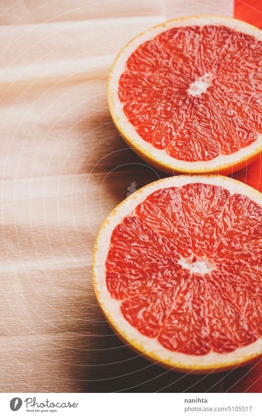 Colorful background in coral and red with fresh open grapefruit texture paper orange peach color juicy new citric healthy temptation vegan vibrant colorful