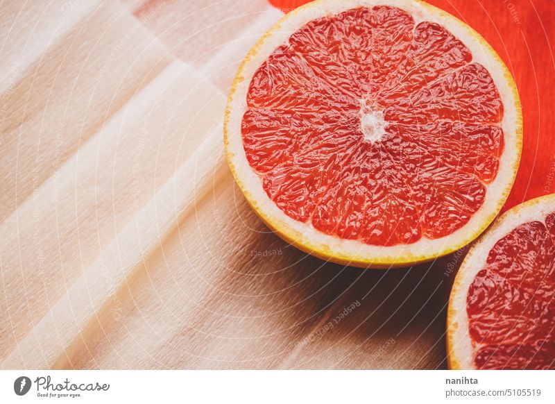 Colorful background in coral and red with fresh open grapefruit texture paper orange peach color juicy new citric healthy temptation vegan vibrant colorful