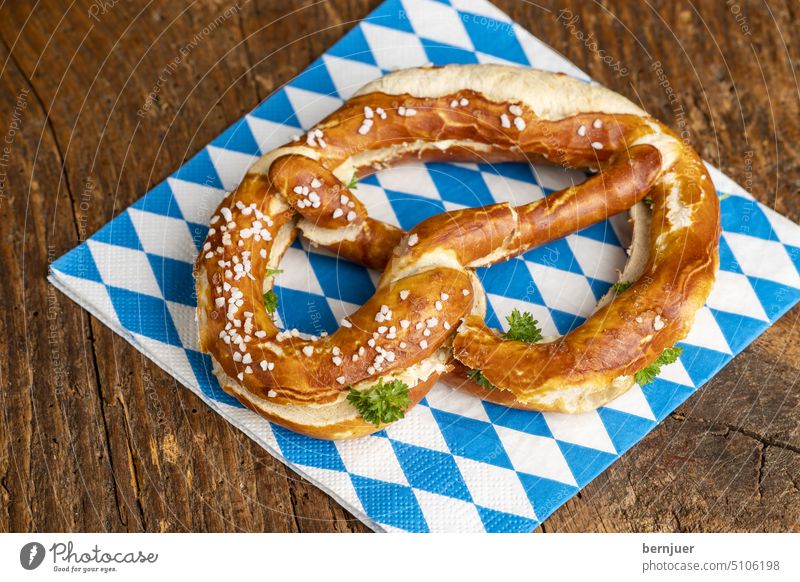 Bavarian butter pretzel on wood Butter pretzel Pretzel Blue White Fresh biscuits Eating Oktoberfest Germany Snack bar traditionally Bakery Culture Kitchen