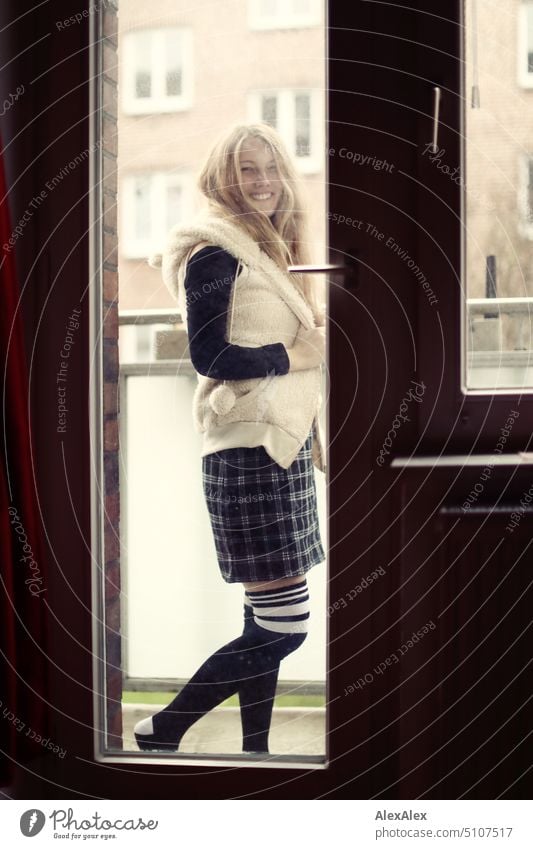 Portrait through balcony door of young blonde woman in dress and stockings portrait Woman Young woman Balcony French windows Armchair Legs Sock Dress Blonde