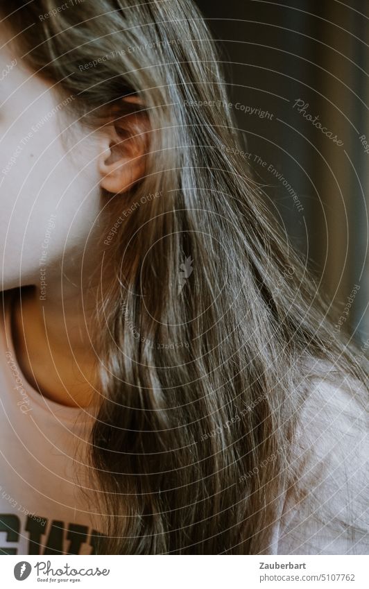 Long hair, ear and cheek of girl in t-shirt looking to the side Ear Cheek Girl T-shirt Meditative pretty Mysterious portrait Neck youthful Hair and hairstyles