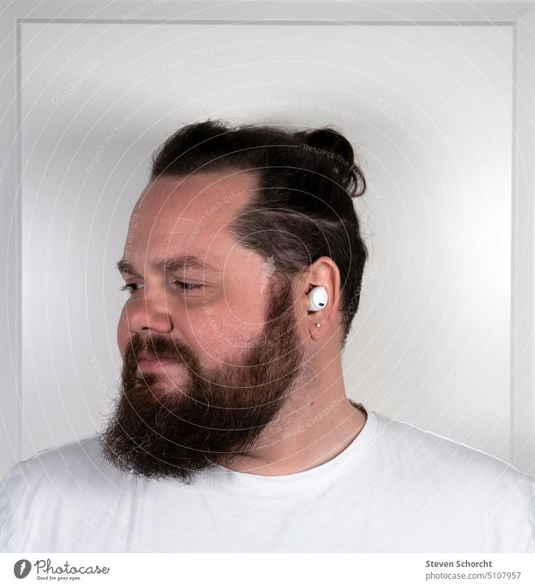 Man with beard and braid listens to music Music Facial hair Masculine portrait Face Adults Head Young man Human being Braids White white t-shirt